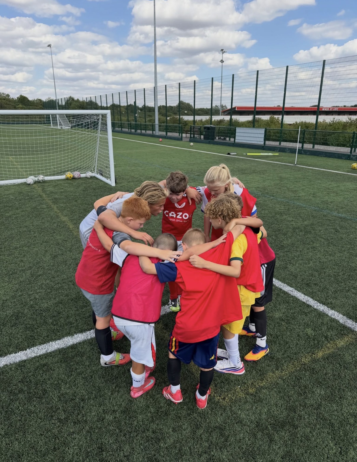 A football team huddle during a Path2Pro session