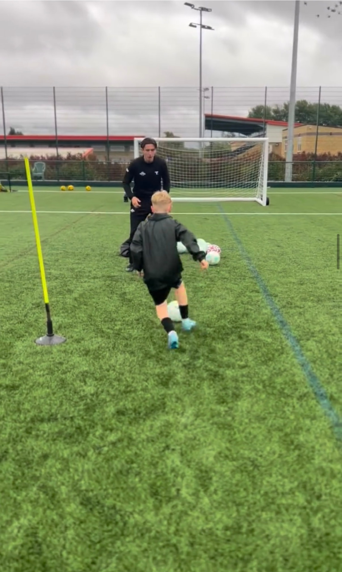 A coach guiding an individual ball drill